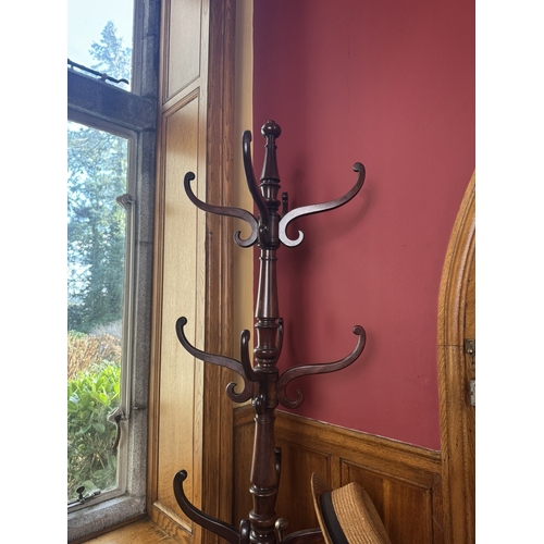 51 - 19th. C. mahogany twelve branch hallstand with turned column and circular base raised on bun feet. {... 