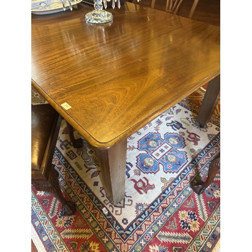 519 - 1950's mahogany dining table, raised on square tapered legs. {74 cm H x 182 cm W x 120 cm D}.