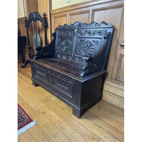 54 - 19th. C. carved oak monk's bench with lift up seat, the seat ends decorated with gargoyles.  { 98cm ... 