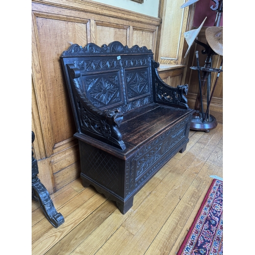 54 - 19th. C. carved oak monk's bench with lift up seat, the seat ends decorated with gargoyles.  { 98cm ... 