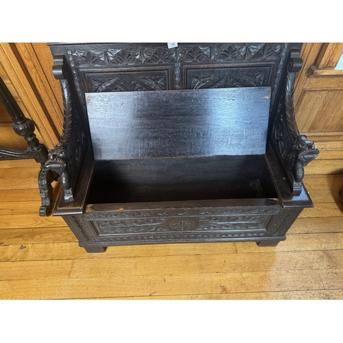 54 - 19th. C. carved oak monk's bench with lift up seat, the seat ends decorated with gargoyles.  { 98cm ... 