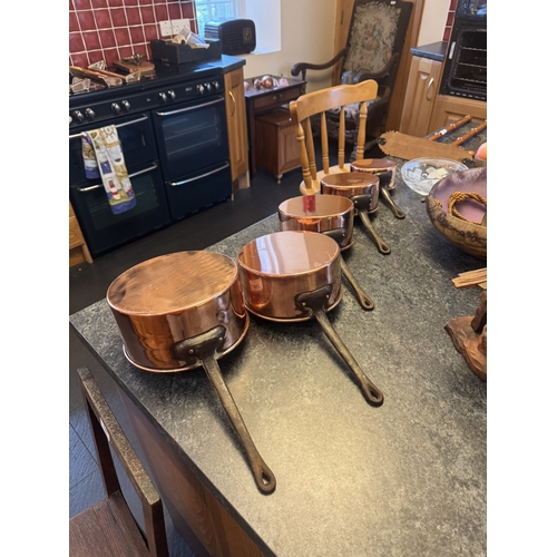 547 - Set of five graduated French copper and wrought iron saucepans. {18 cm H x 38 cm W x 31 cm D to 12 c... 