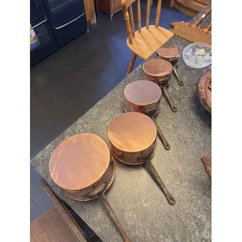 547 - Set of five graduated French copper and wrought iron saucepans. {18 cm H x 38 cm W x 31 cm D to 12 c... 