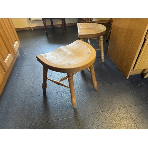 554 - Pair of unusual oak kitchen stools, raised on splayed legs. {43 cm H x 58 cm W  x38 cm D}