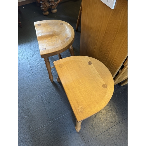 554 - Pair of unusual oak kitchen stools, raised on splayed legs. {43 cm H x 58 cm W  x38 cm D}