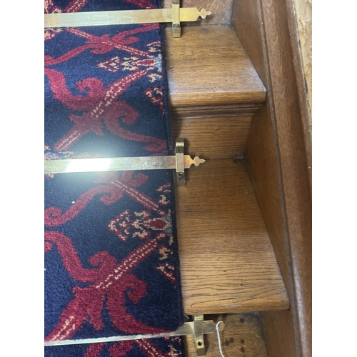 562 - Set of thirteen brass stair rods with keepers.  { 105cm W }.