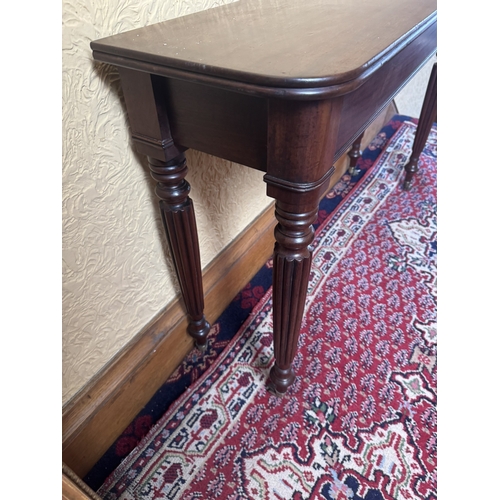 567 - Will. IV. Mahogany side table raised on reeded legs and brass casters. { 71cm H X 112cm W X 31cm D }... 