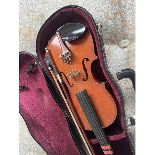 606 - Violin with bow,  in case. { 53cm L }.