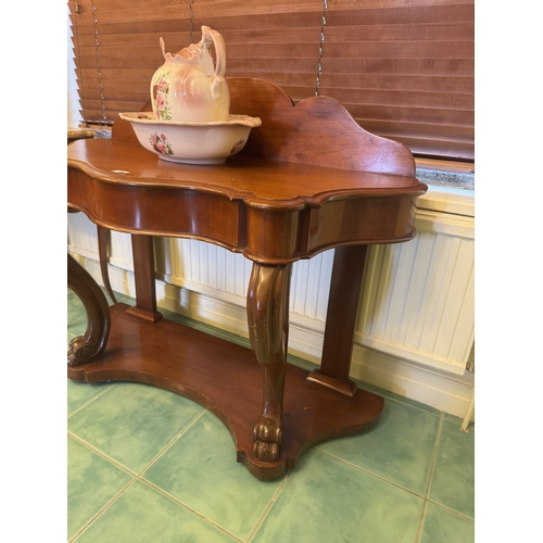 620 - 19th. C. mahogany dressing table, the shaped gallery back above a shaped front, raised on scrolled l... 