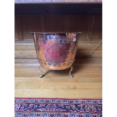 63 - 19th. C. copper and brass log bucket, raised on paw feet. { 47cm H X 61cm Dia }.