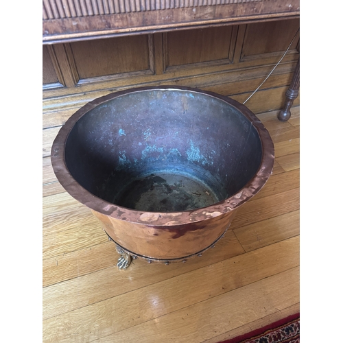 63 - 19th. C. copper and brass log bucket, raised on paw feet. { 47cm H X 61cm Dia }.