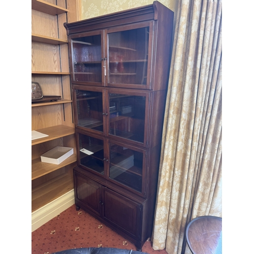 646 - 1930's mahogany sectional bookcase with six glazed doors over two raised panelled doors, raised on t... 