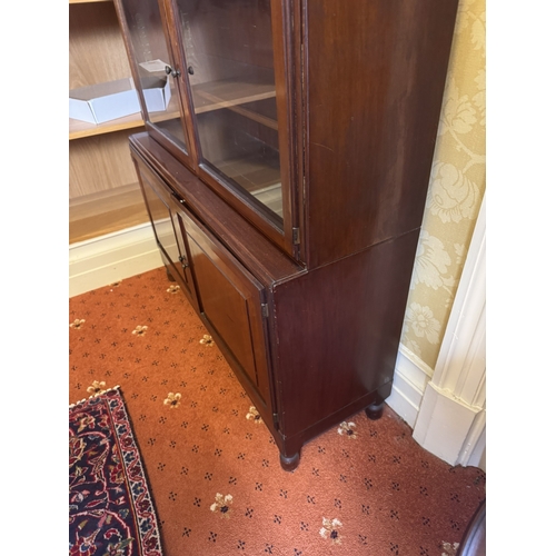 646 - 1930's mahogany sectional bookcase with six glazed doors over two raised panelled doors, raised on t... 