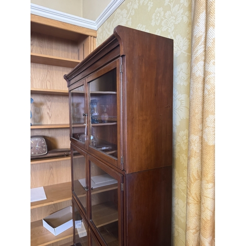 646 - 1930's mahogany sectional bookcase with six glazed doors over two raised panelled doors, raised on t... 