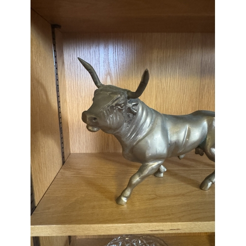 655 - Brass model of a bull. { 22cm H X 38cm W X 10cm D }.