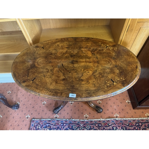 662 - 19th. C. inlaid walnut centre table with oval top, raised on four turned coumns and four outswept ca... 