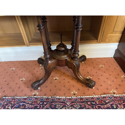 662 - 19th. C. inlaid walnut centre table with oval top, raised on four turned coumns and four outswept ca... 