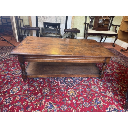 666 - 20th. C. oak reading table, raised on turned legs and with lower shelf. { 47cm H X 153cm W X 92cm D ... 