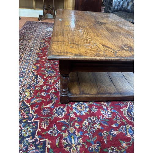 666 - 20th. C. oak reading table, raised on turned legs and with lower shelf. { 47cm H X 153cm W X 92cm D ... 