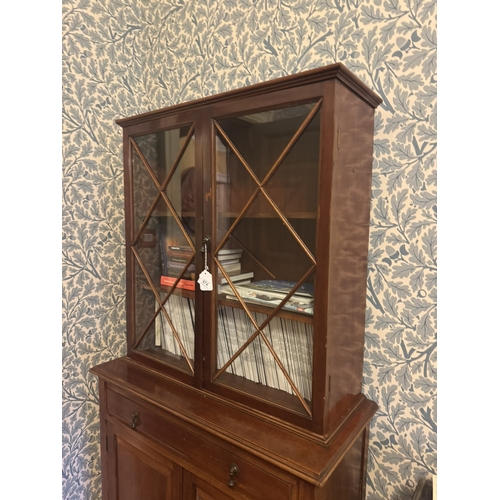 674 - Edwardian mahogany bookcase, the two astragal glazed doors over one long drawer, two raised panelled... 