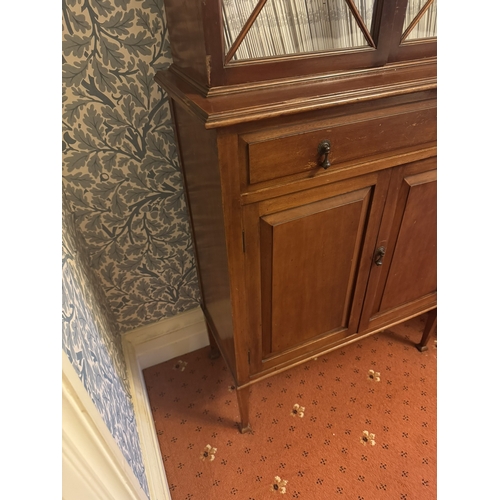 674 - Edwardian mahogany bookcase, the two astragal glazed doors over one long drawer, two raised panelled... 