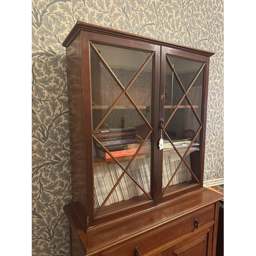 674 - Edwardian mahogany bookcase, the two astragal glazed doors over one long drawer, two raised panelled... 