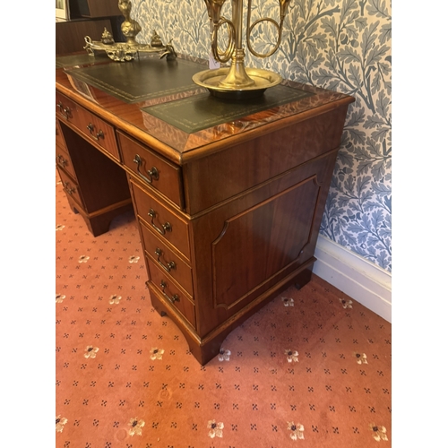 676 - Late 20th. C. mahogany knee holed desk with tooled leather top the centre drawer flanked with two sh... 