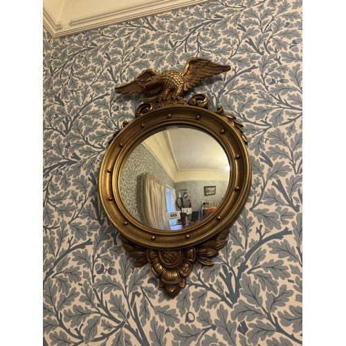 689 - 20th. C. moulded gilt framed wall mirror surmounted with an eagle { 73cm H X 44cm W }.