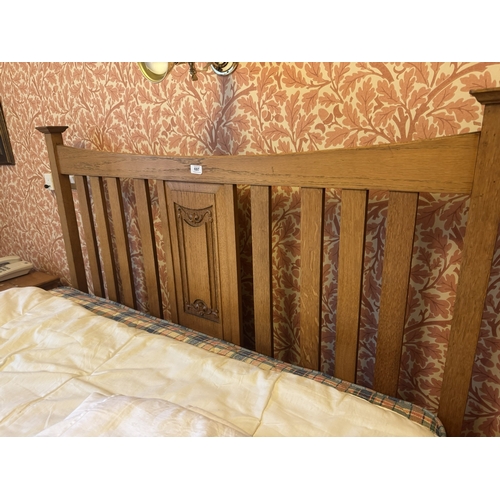 697 - Art Nouveau oak bed with mattress. { 139cm H X 137cm W }.