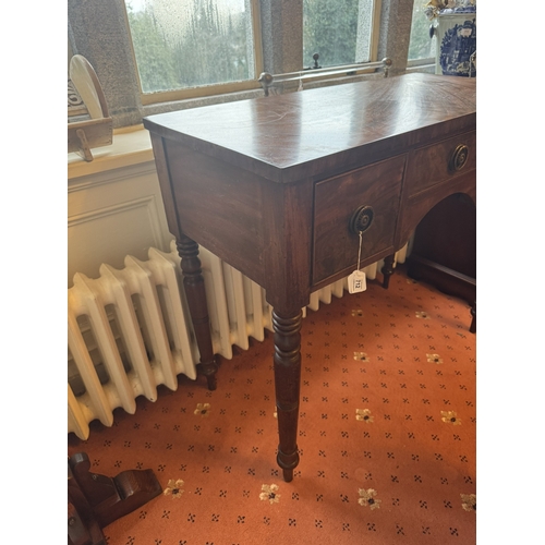 712 - Georgian mahogany kneehole desk, the short centre drawer flanked by two deep drawers, raised on turn... 