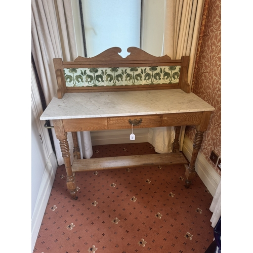 716 - Art Nouveau oak wash stand, the tiled back above single drawer in the frieze, raised on turned legs ... 