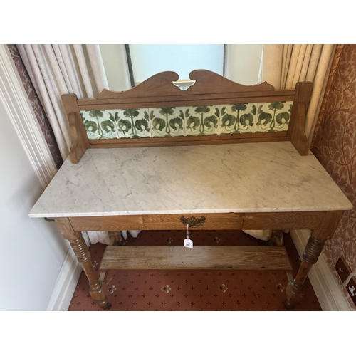 716 - Art Nouveau oak wash stand, the tiled back above single drawer in the frieze, raised on turned legs ... 