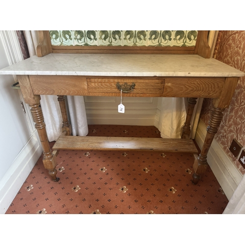 716 - Art Nouveau oak wash stand, the tiled back above single drawer in the frieze, raised on turned legs ... 