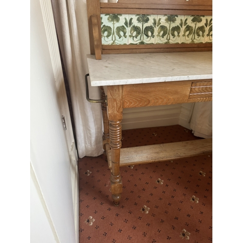 716 - Art Nouveau oak wash stand, the tiled back above single drawer in the frieze, raised on turned legs ... 