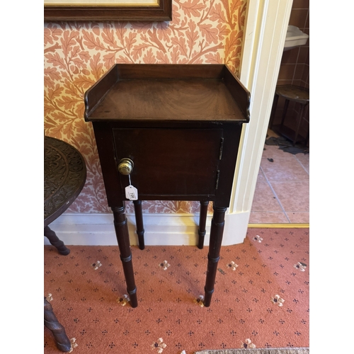 720 - Georgian mahogany pot cupboard, the gallery back above a single door, raised on tapered ringed legs.... 