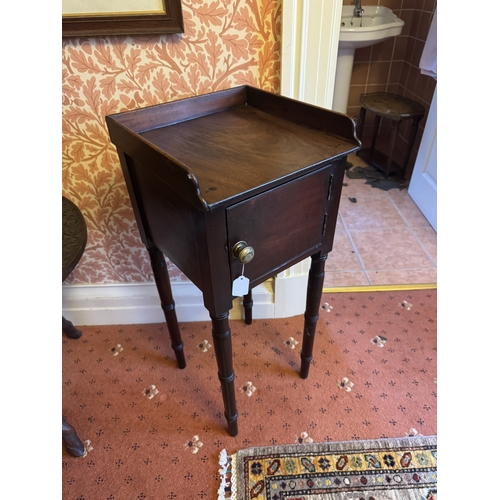 720 - Georgian mahogany pot cupboard, the gallery back above a single door, raised on tapered ringed legs.... 