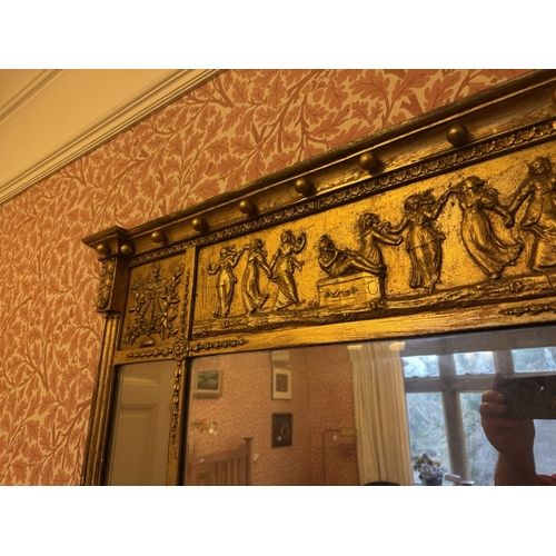 724 - Regency gilt overmantle, the inverted breakfront cornice with ball mounts above a frieze depicting d... 