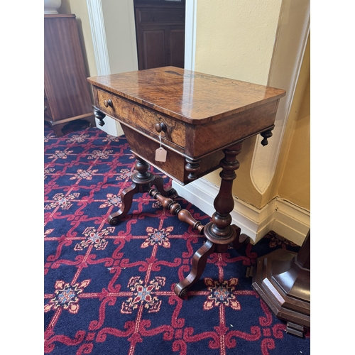 748 - 19th. C. walnut sewing table with sliding basket in the frieze, raised  on turned columns, outswept ... 