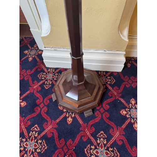 750 - 19th. C. mahogany torchere, raised on tapered octagonal column and base. { 107cm H X 34cm Dia. }.