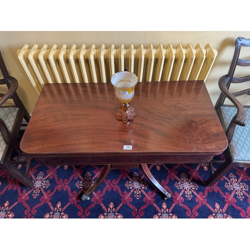 764 - Regency inlaid  mahogany turn over tea table, raised on fout turned columns, three outawpt feet term... 