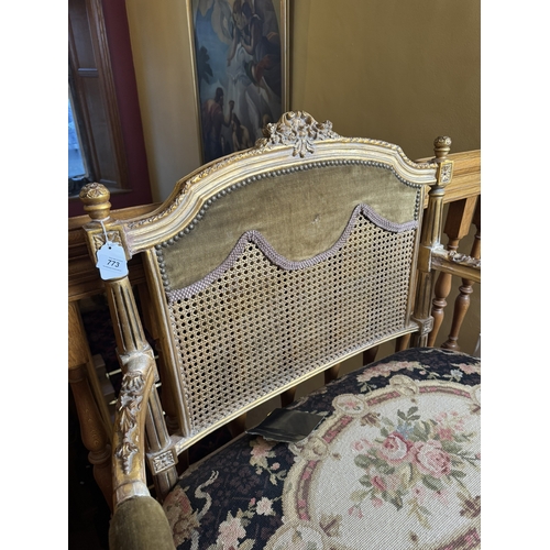 773 - 19th. C. giltwood two seater bench with bergere back and upholstered seat, raised on carved reeded t... 