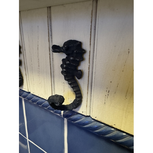 817 - Painted pine wall coat hanger, the hooks in the form of sea horses. { 22cm H X 88cm W X 11cm D }.