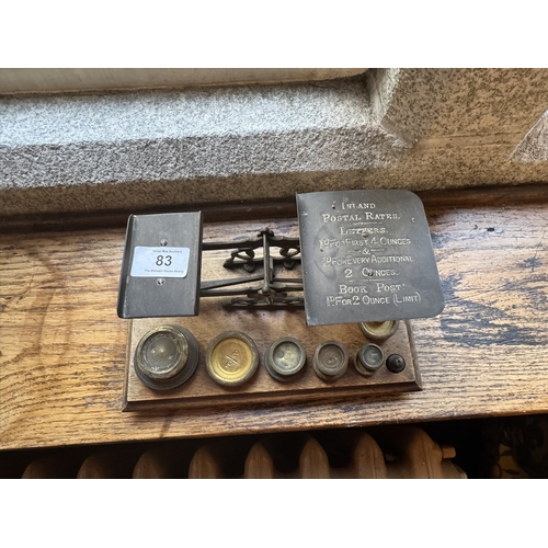 83 - 19th. C. brass and oak postal scales with brass weights. { 10cm H X  24cm W X 13cm D }.