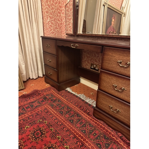 844 - Modern mahogany dressing , the three mirrors above a long centre drawer flanked by six short drawers... 