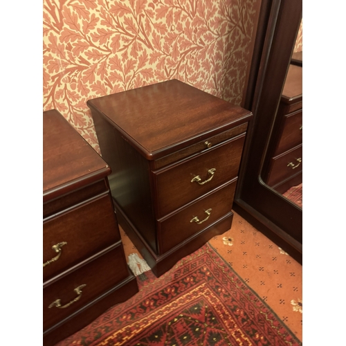 845 - Pair of modern mahogany bedside lockers with a brushing slide above two short drawers, raised on pli... 