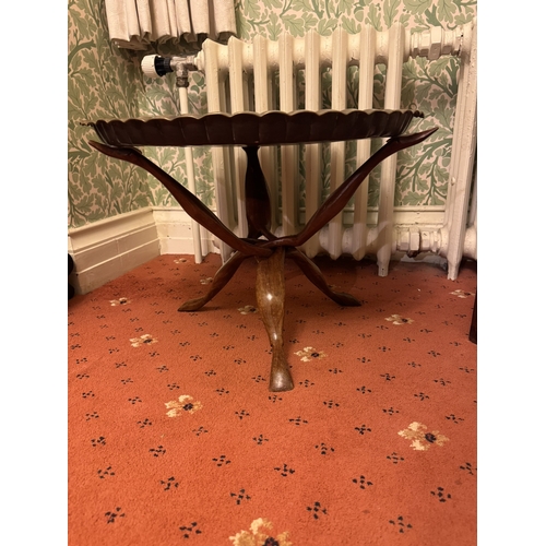 865 - Middle Eastern brass topped table raised on folding frame. { 38cmH X 55cm Dia }.