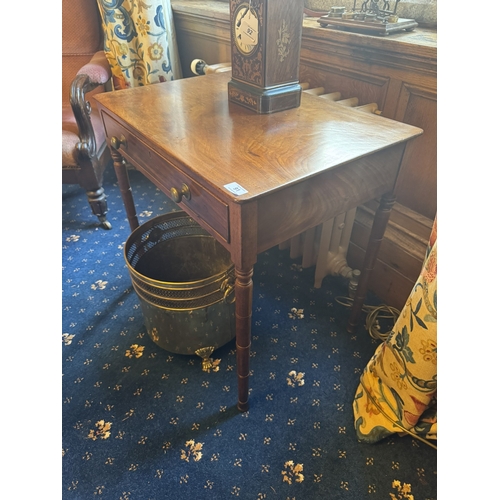 91 - Georgian mahogany writing table with single long drawer in the frieze, raised on turned legs. { 63cm... 