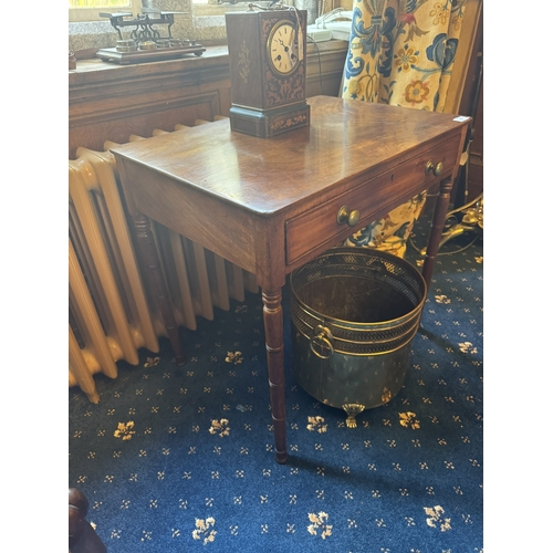 91 - Georgian mahogany writing table with single long drawer in the frieze, raised on turned legs. { 63cm... 