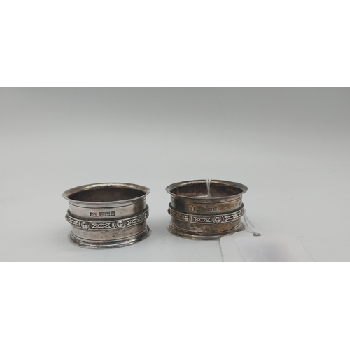 1009 - Pair of English silver Celtic Knot design napkin rings. Hallmarked in Birmingham. Maker: David Lawre... 