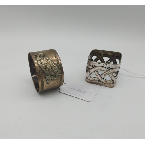 1010 - Two silver plated napkin rings . Square holder stamped WMFN x/o OX. Circular holder decorated with a... 